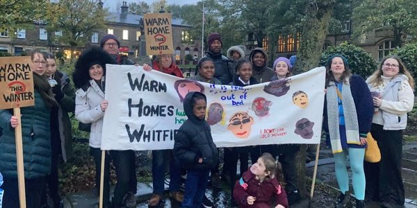 Picture of people holding a banner which says Warm Homes Whitfield