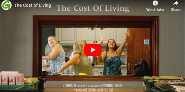 Video player - image shows women dancing in a community kitchen. The film title is The cost of living